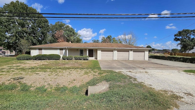 ranch-style house featuring a garage and a front lawn