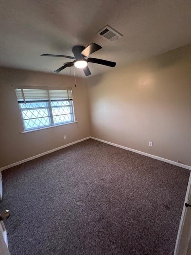 empty room with ceiling fan and carpet floors