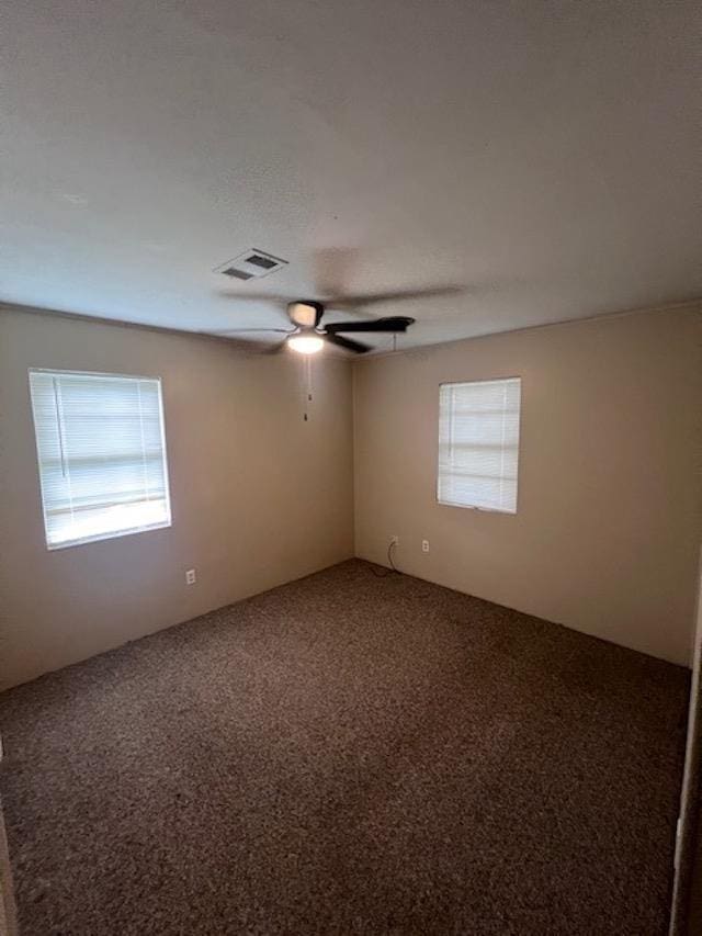 empty room with carpet and ceiling fan