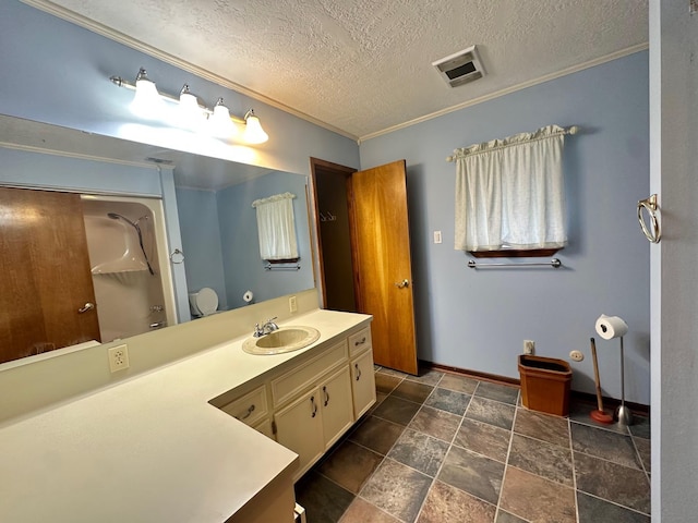 bathroom with vanity, crown molding, and a textured ceiling