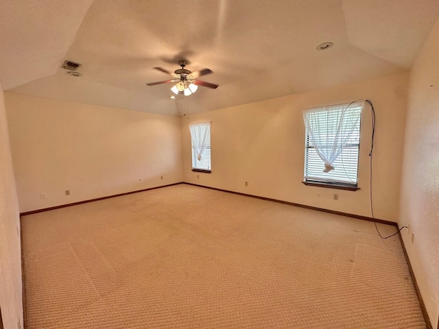 carpeted empty room with vaulted ceiling and ceiling fan