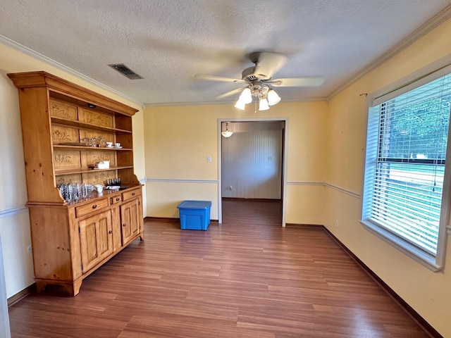 dining room featuring a textured ceiling, plenty of natural light, ceiling fan, and ornamental molding