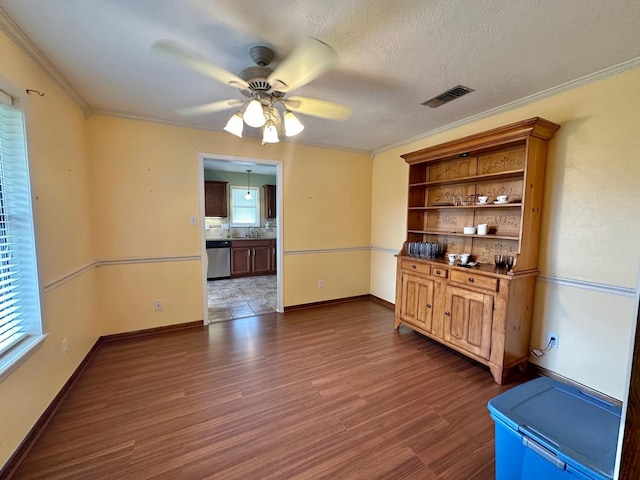 interior space with sink, crown molding, ceiling fan, dark hardwood / wood-style floors, and a textured ceiling