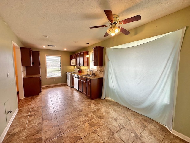 kitchen with ceiling fan, sink, light tile patterned flooring, and white appliances