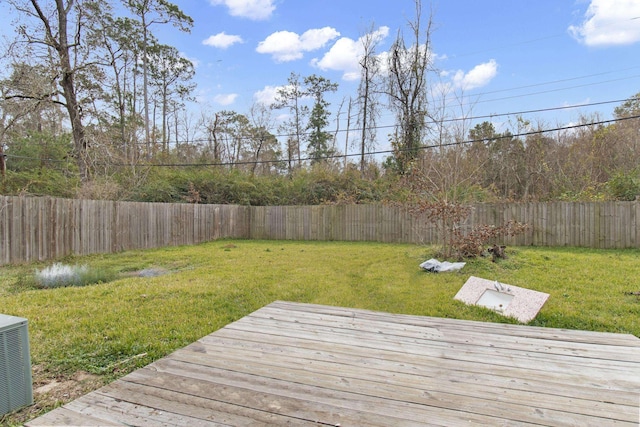 deck with central AC unit and a yard