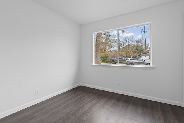 spare room with dark hardwood / wood-style floors