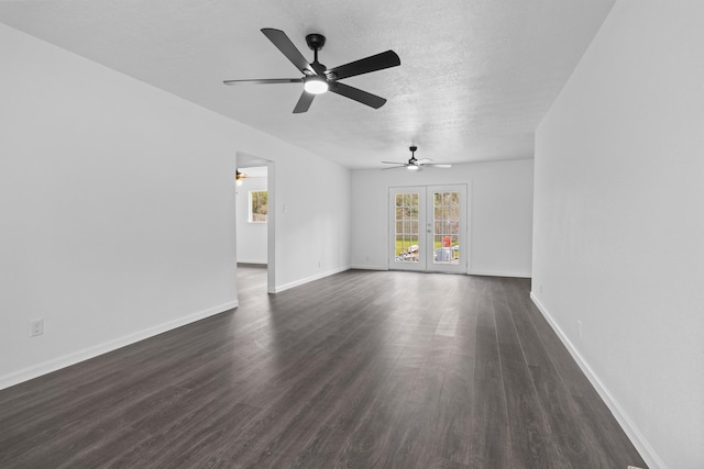 unfurnished living room with french doors, dark hardwood / wood-style flooring, and a textured ceiling