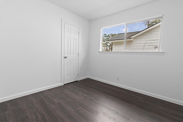 spare room featuring dark hardwood / wood-style flooring