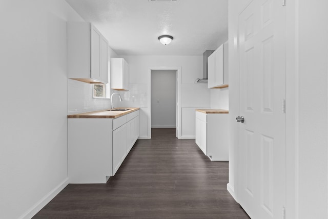 kitchen featuring sink, white cabinetry, backsplash, and dark hardwood / wood-style floors