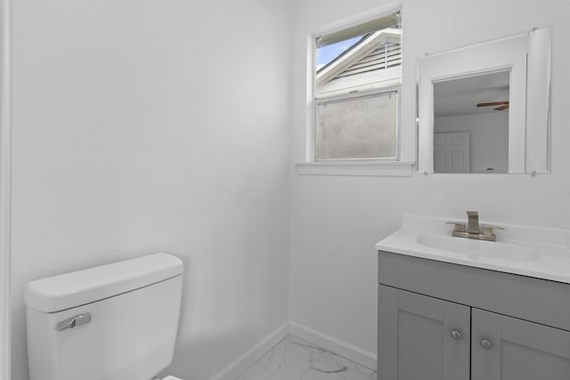 bathroom featuring ceiling fan, vanity, and toilet