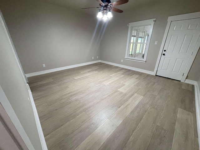 interior space featuring a ceiling fan, wood finished floors, and baseboards