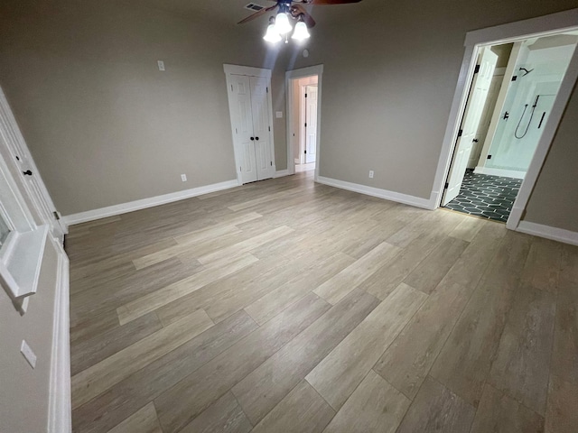 interior space with light wood-style flooring, baseboards, and ceiling fan