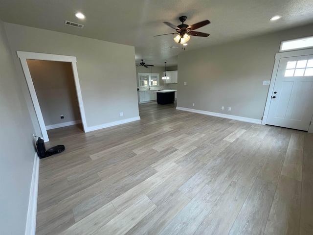 unfurnished living room with recessed lighting, baseboards, light wood-style flooring, and a ceiling fan