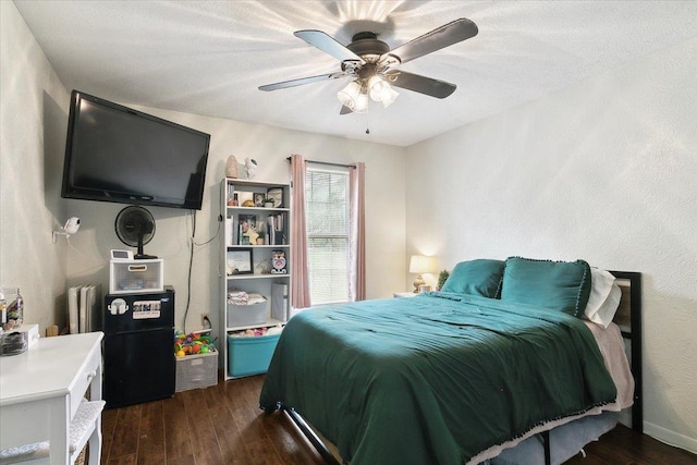 bedroom featuring ceiling fan and dark wood-type flooring