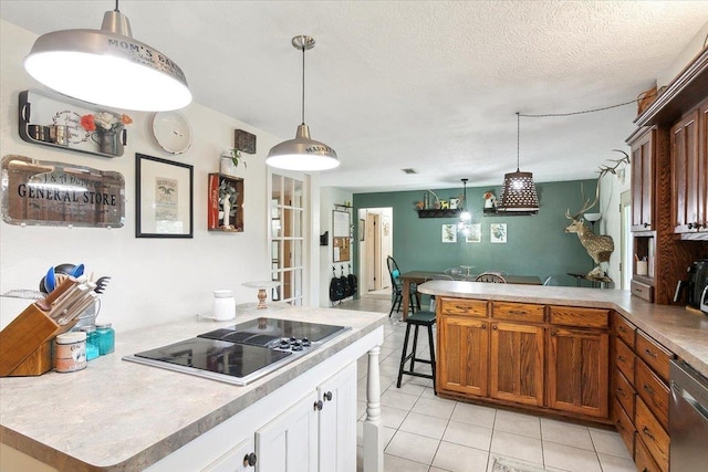 kitchen with dishwasher, pendant lighting, a textured ceiling, black electric cooktop, and light tile patterned flooring