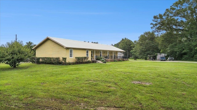 exterior space featuring a porch and a lawn