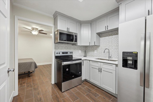 11503 Davidson Rd, Beaumont, TX 77705 - kitchen with appliances with stainless steel finishes, light countertops, backsplash, a ceiling fan, and dark wood finished floors