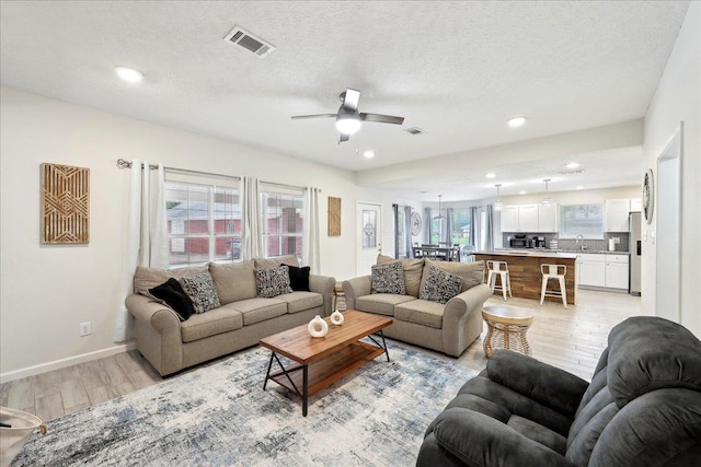 11503 Davidson Rd, Beaumont, TX 77705 - living area with light wood-style floors, ceiling fan, recessed lighting, and a textured ceiling