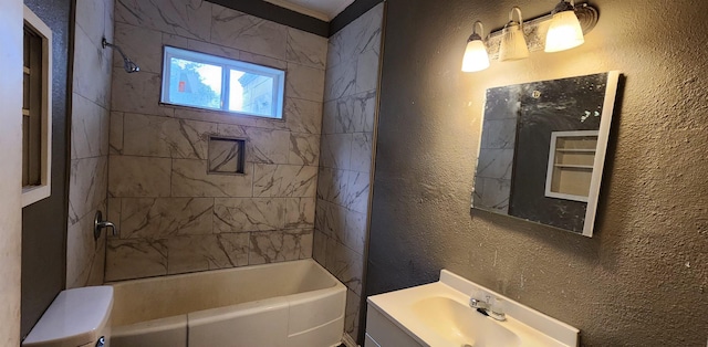 full bathroom featuring vanity, toilet, and tiled shower / bath