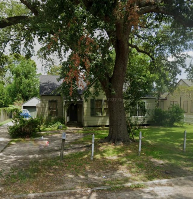 obstructed view of property featuring a front yard