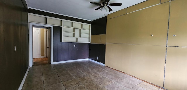 unfurnished room featuring tile patterned floors and ceiling fan