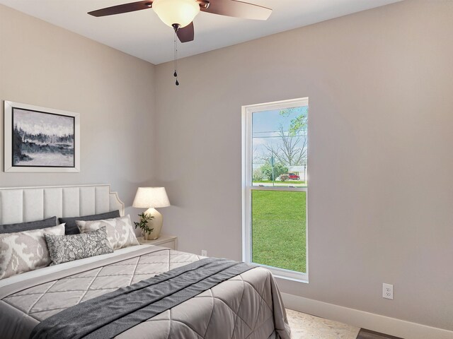 spare room with baseboards, a ceiling fan, and dark wood finished floors