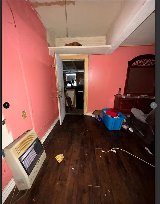 hall with heating unit and dark wood-type flooring