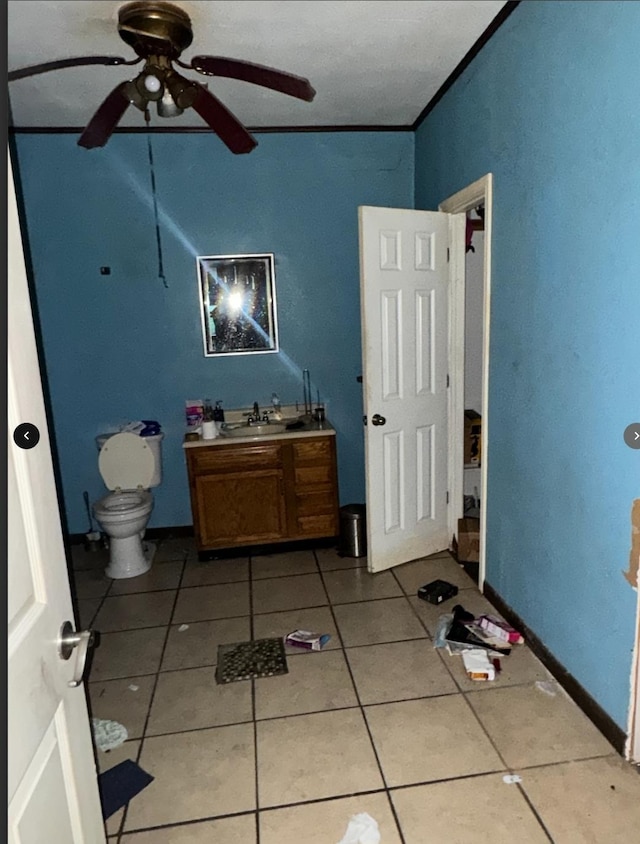 bathroom featuring vanity, tile patterned flooring, ceiling fan, toilet, and ornamental molding