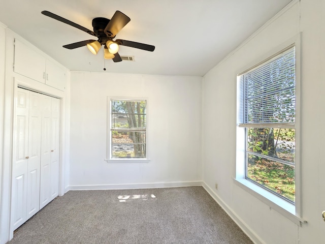 unfurnished bedroom featuring a closet, ceiling fan, and carpet flooring