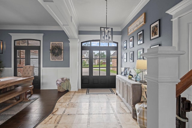220 Idylwild Dr, Sour Lake, TX 77659 - foyer entrance featuring an inviting chandelier, ornamental molding, ornate columns, and a wainscoted wall