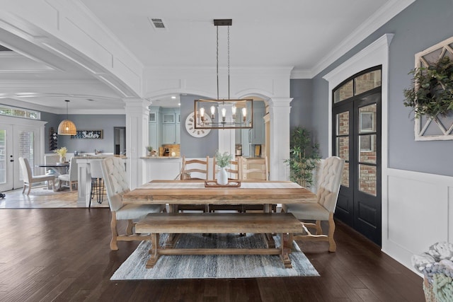 220 Idylwild Dr, Sour Lake, TX 77659 - dining space featuring crown molding, wood-type flooring, decorative columns, and a chandelier
