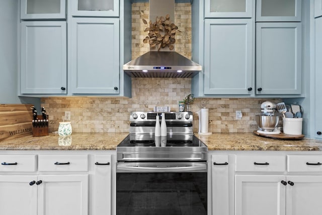 220 Idylwild Dr, Sour Lake, TX 77659 - kitchen featuring wall chimney range hood, backsplash, glass insert cabinets, and electric stove