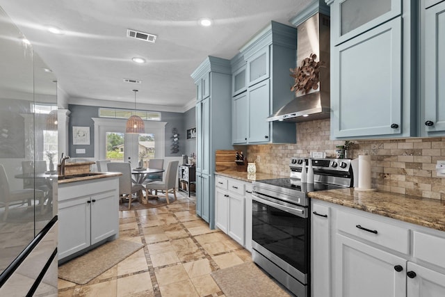 220 Idylwild Dr, Sour Lake, TX 77659 - kitchen with visible vents, stainless steel range with electric stovetop, glass insert cabinets, wall chimney exhaust hood, and a sink
