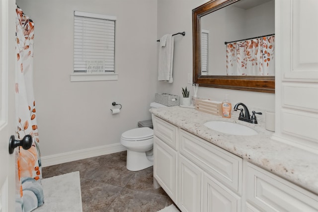 bathroom with tile patterned floors, vanity, and toilet