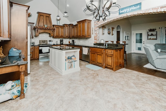 kitchen featuring pendant lighting, backsplash, a center island, and stainless steel appliances