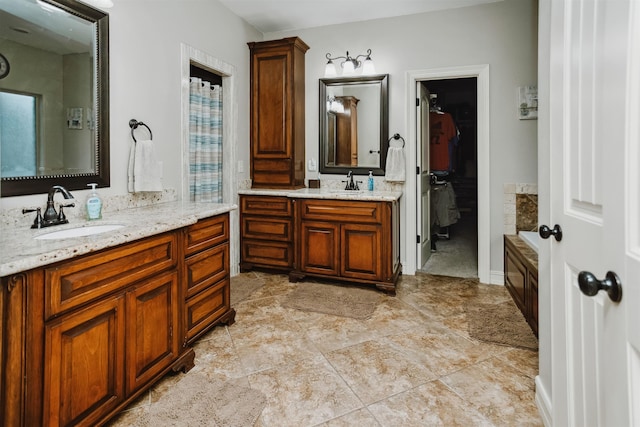 bathroom with vanity and a bath