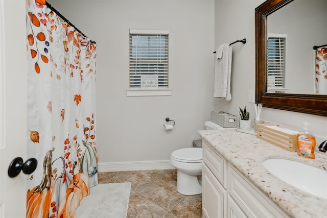 bathroom with tile patterned floors, vanity, and toilet