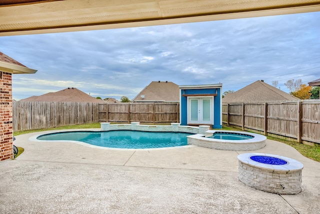 view of swimming pool featuring an outdoor fire pit, a patio, and an in ground hot tub