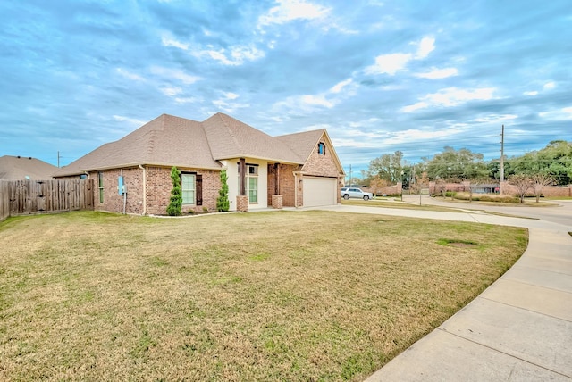 view of front of home with a front yard and a garage