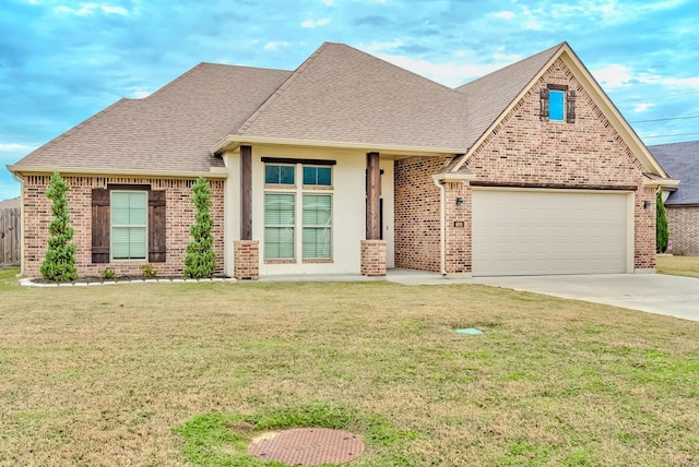 view of front of house with a front lawn and a garage