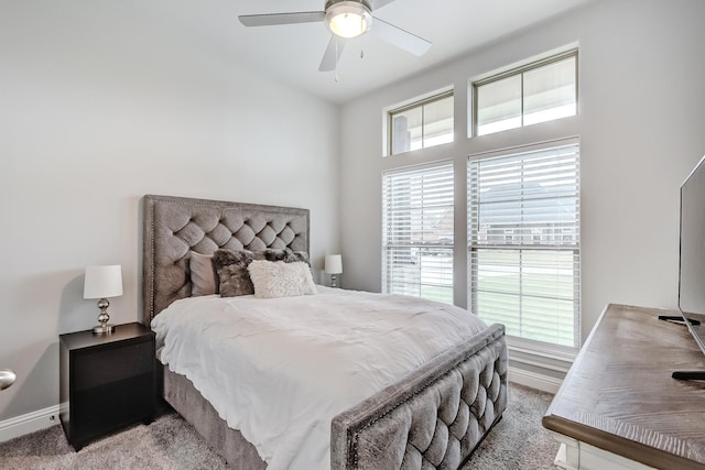 bedroom with ceiling fan, light carpet, and multiple windows