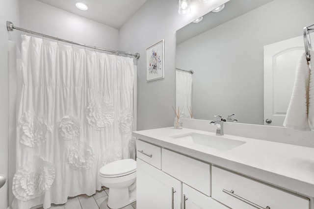 bathroom with tile patterned flooring, vanity, and toilet