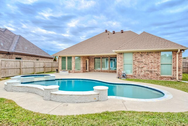 view of pool featuring a patio area and an in ground hot tub