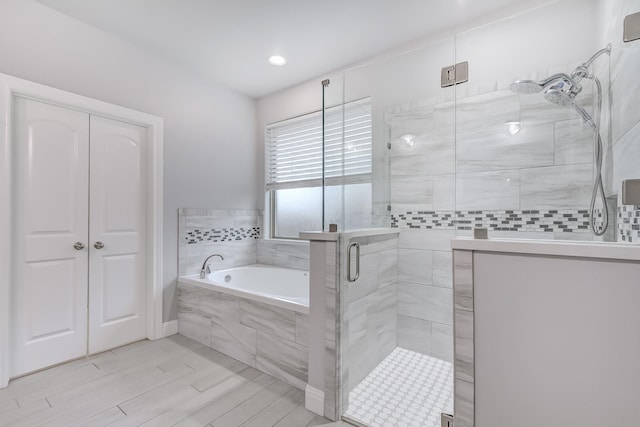 bathroom with separate shower and tub