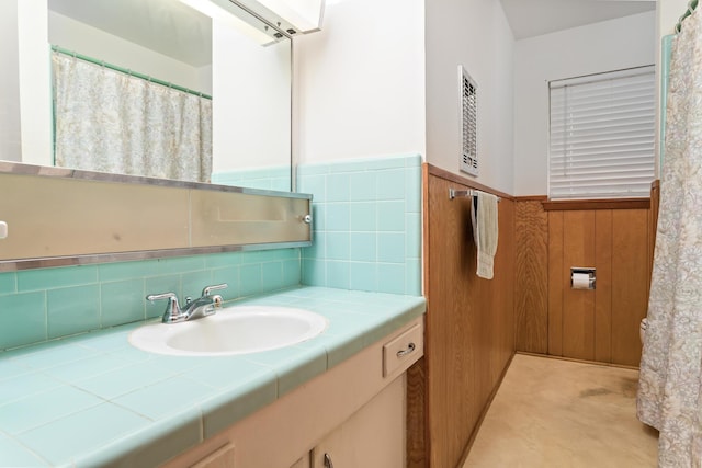 6355 Arrowhead Dr, Beaumont, TX 77707 - bathroom with vanity and a wainscoted wall