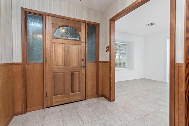 6355 Arrowhead Dr, Beaumont, TX 77707 - entryway with light tile patterned floors, a wainscoted wall, visible vents, and wallpapered walls
