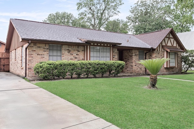 6355 Arrowhead Dr, Beaumont, TX 77707 - view of front facade with a front lawn, brick siding, and roof with shingles