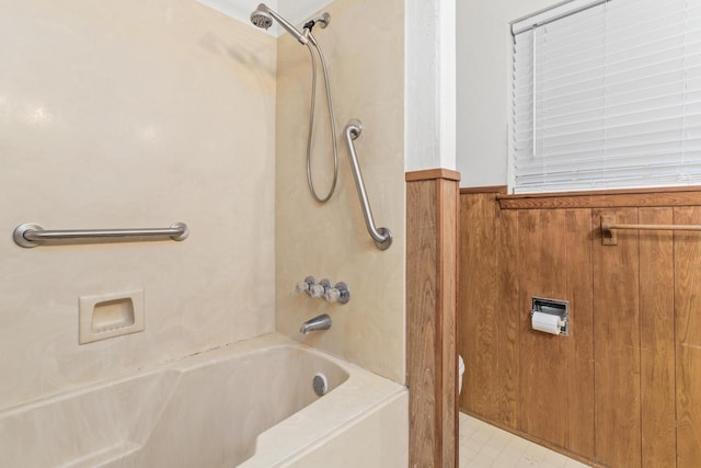 6355 Arrowhead Dr, Beaumont, TX 77707 - bathroom with a wainscoted wall, wooden walls, and shower / bath combination
