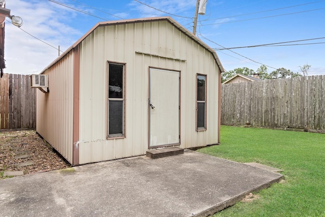 6355 Arrowhead Dr, Beaumont, TX 77707 - view of outdoor structure with a wall mounted AC, an outdoor structure, and a fenced backyard