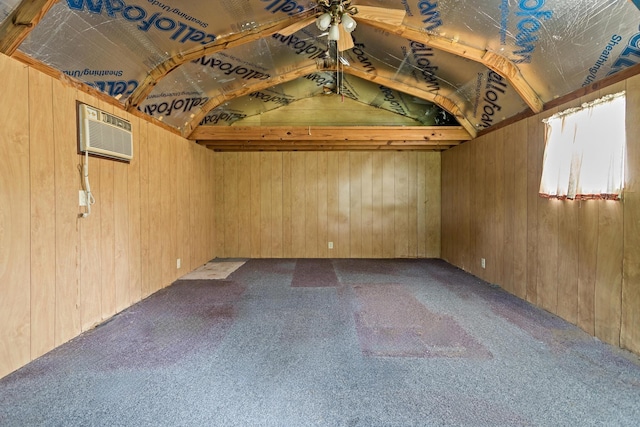 6355 Arrowhead Dr, Beaumont, TX 77707 - spare room featuring wood walls, a wall mounted air conditioner, carpet floors, and vaulted ceiling